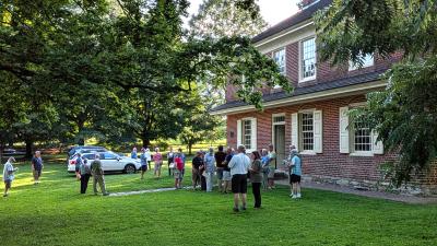 Visitors gather in front of Primitive Hall