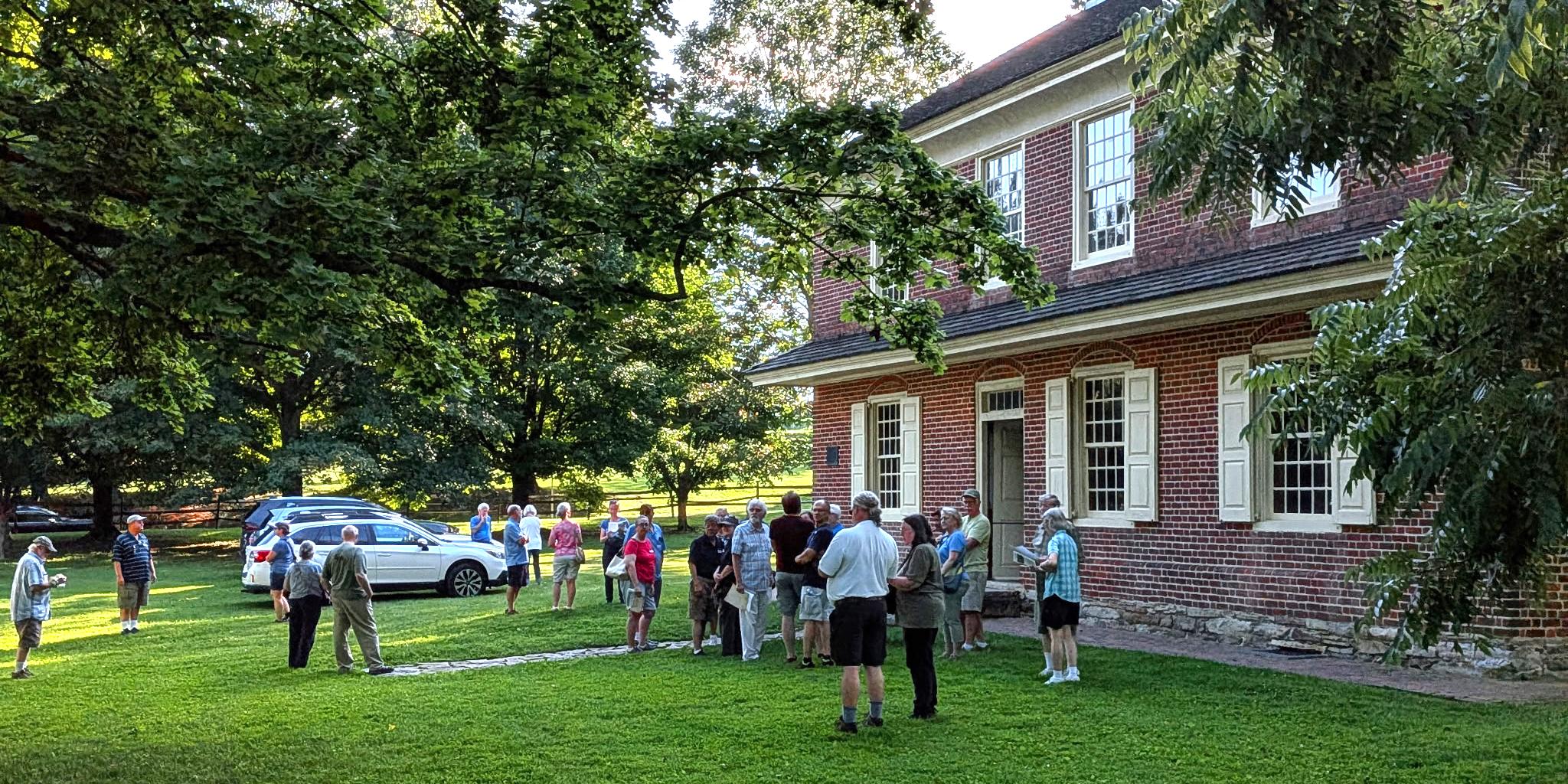 Visitors gather in front of Primitive Hall